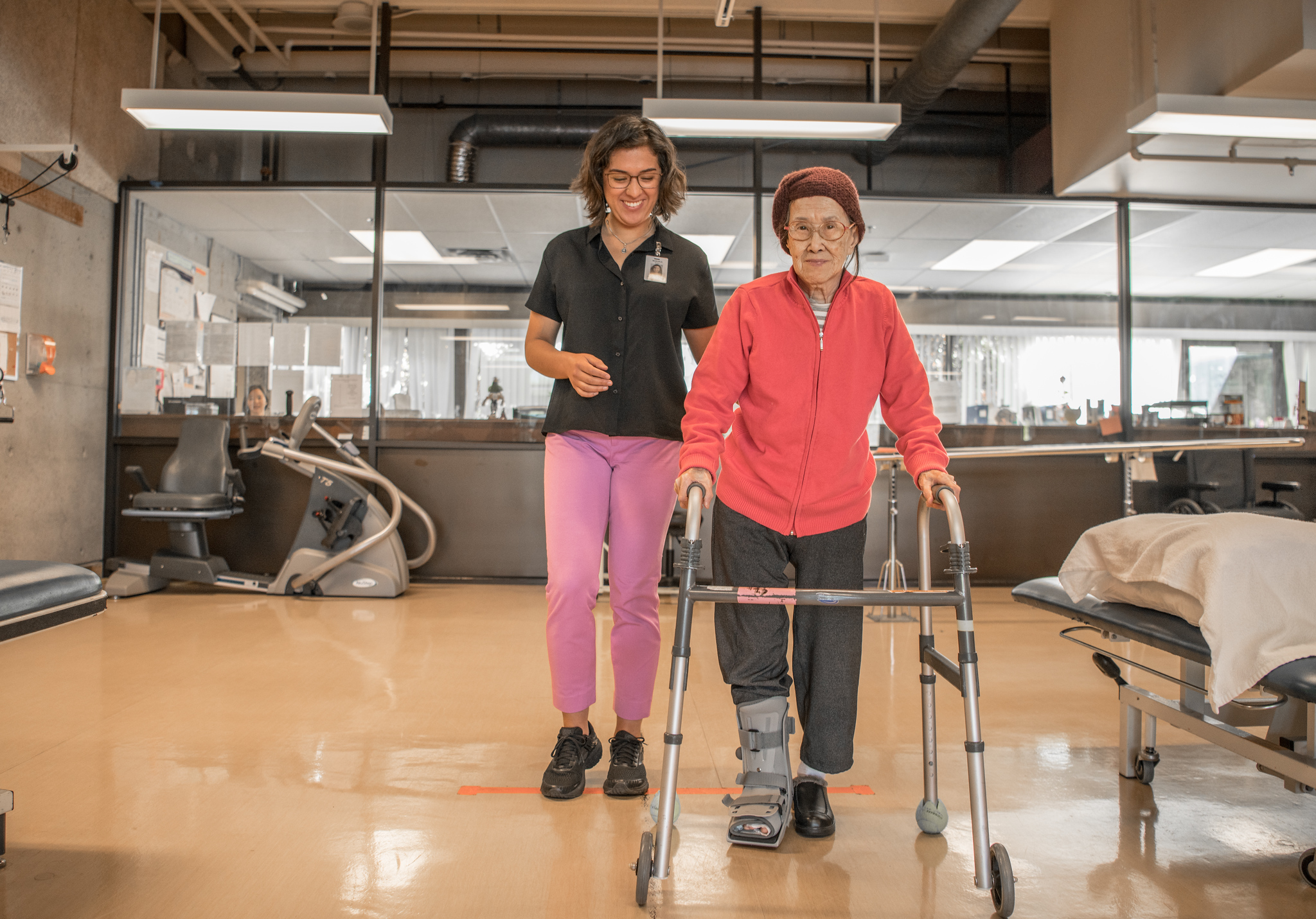 The cover image of the project portrays a caregiver walking behind a senior woman.