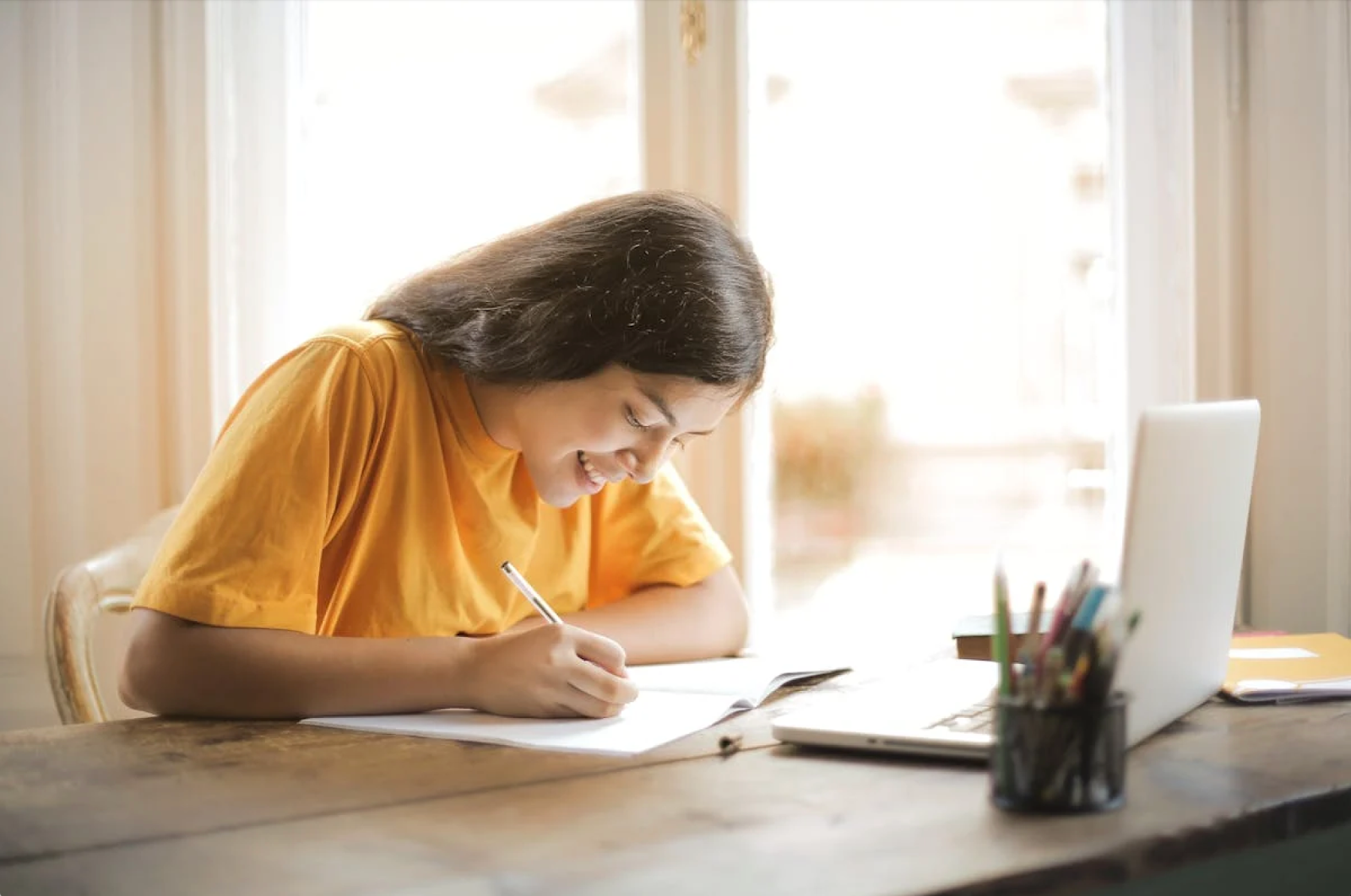 Person writing at desk